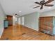 Spacious bedroom with hardwood floors, ceiling fans, and ample natural light; two decorative storage cabinets also present at 3122 Harmony Rd, Temple, GA 30179