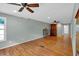 Large bedroom featuring hardwood floors, two ceiling fans, and natural light; cabinets on left and right of the space at 3122 Harmony Rd, Temple, GA 30179