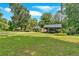 Grassy front yard with house in the background and a covered parking structure on the right at 3122 Harmony Rd, Temple, GA 30179