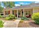 Inviting front porch with red chairs surrounded by well-maintained landscaping at 3122 Harmony Rd, Temple, GA 30179