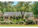 Quaint one-story home with red shutters and a well-maintained front yard with mature landscaping at 3122 Harmony Rd, Temple, GA 30179