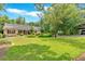 Charming home with a lush green lawn and mature trees, creating a welcoming curb appeal at 3122 Harmony Rd, Temple, GA 30179