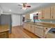Classic kitchen with granite countertops, natural wood cabinets, view through an opening, and stainless steel refrigerator at 3122 Harmony Rd, Temple, GA 30179