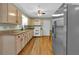 Bright kitchen features stainless steel refrigerator, granite countertops, and natural wood cabinets with modern appliances at 3122 Harmony Rd, Temple, GA 30179