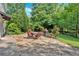 Stone patio with outdoor dining set, creating a perfect space for entertaining and relaxing at 3122 Harmony Rd, Temple, GA 30179