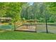 Picturesque pond with a wooden pier and outdoor seating at 3122 Harmony Rd, Temple, GA 30179