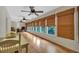 Inviting sunroom features wood floors, multiple windows with bamboo shades, and natural light; ceiling fan also visible at 3122 Harmony Rd, Temple, GA 30179