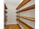 Spacious walk-in closet features hardwood floors and custom wood shelving at 3122 Harmony Rd, Temple, GA 30179
