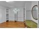 Bright walk-in closet features custom shelving, hardwood floors and natural light at 3122 Harmony Rd, Temple, GA 30179