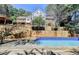 Backyard has a swimming pool, extensive wooden deck, and multi-level terraced landscaping at 4070 Runnnymede, Lilburn, GA 30047