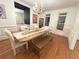 Bright dining room with modern lighting, hardwood floors, and a large dining table at 4070 Runnnymede, Lilburn, GA 30047