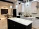 Modern kitchen with black and white cabinets, marble countertops, stainless steel appliances and pendant lighting at 4070 Runnnymede, Lilburn, GA 30047