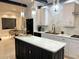 Modern kitchen with black and white cabinets, marble countertops, stainless steel appliances and pendant lighting at 4070 Runnnymede, Lilburn, GA 30047