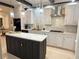 Modern kitchen with black and white cabinets, marble countertops, stainless steel appliances and pendant lighting at 4070 Runnnymede, Lilburn, GA 30047