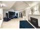 Modern living room with plush seating, fireplace, dark accent wall and marble floors at 4070 Runnnymede, Lilburn, GA 30047