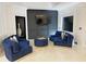 Living room with plush blue seating, dark accent wall and gold trim at 4070 Runnnymede, Lilburn, GA 30047
