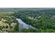 Expansive aerial shot highlighting the community's serene lake and its proximity to lush, wooded areas at 4138 Glenlake Nw Ter, Kennesaw, GA 30144