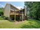 Spacious backyard with a tiered deck, screened-in porch and lush green lawn at 4138 Glenlake Nw Ter, Kennesaw, GA 30144