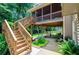 Multi-level deck and patio with wood stairs leading to the well-manicured backyard and mature trees at 4138 Glenlake Nw Ter, Kennesaw, GA 30144