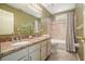 Bathroom showcasing double sinks, granite counters and tub with shower at 4138 Glenlake Nw Ter, Kennesaw, GA 30144