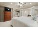 Bright bedroom featuring a comfortable bed, a dresser with a TV, and a doorway leading to a closet at 4138 Glenlake Nw Ter, Kennesaw, GA 30144