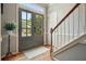 Entryway with staircase, hardwood floors, a stylish doormat, and glass paned double doors at 4138 Glenlake Nw Ter, Kennesaw, GA 30144
