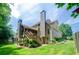 Back exterior of home featuring a screened in porch, a deck and lush green backyard at 4138 Glenlake Nw Ter, Kennesaw, GA 30144