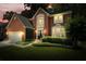 Charming two-story brick home featuring an inviting front yard and an attached two-car garage at 4138 Glenlake Nw Ter, Kennesaw, GA 30144