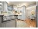 Bright kitchen features white cabinets with granite counters, stainless appliances, and a view to a sunny breakfast room at 4138 Glenlake Nw Ter, Kennesaw, GA 30144