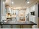 Kitchen area with island, stainless appliances, and white cabinetry with an open concept view of the breakfast room at 4138 Glenlake Nw Ter, Kennesaw, GA 30144