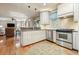 Modern kitchen featuring stainless steel appliances, white cabinetry, granite countertops and view into living room at 4138 Glenlake Nw Ter, Kennesaw, GA 30144
