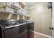 Well-equipped laundry room with a new washer and dryer and ample shelving at 4138 Glenlake Nw Ter, Kennesaw, GA 30144