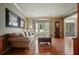 Comfortable living room with hardwood floors, a cozy seating arrangement, and a sunlit bay window at 4138 Glenlake Nw Ter, Kennesaw, GA 30144