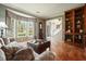 Elegant living room with a bay window, hardwood floors, a cozy sofa, and built-in bookcase at 4138 Glenlake Nw Ter, Kennesaw, GA 30144