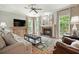 Inviting living room features a brick fireplace, plush seating, and expansive windows overlooking the yard at 4138 Glenlake Nw Ter, Kennesaw, GA 30144