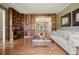 Stylish living room showcasing custom shelving units, hardwood floors, and seamless dining room access at 4138 Glenlake Nw Ter, Kennesaw, GA 30144