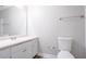 Bathroom with white vanity, sink, toilet, and large mirror at 45 Kelsey Way, Palmetto, GA 30268