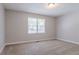 Bedroom featuring neutral carpeting and a large window at 45 Kelsey Way, Palmetto, GA 30268