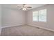 Bedroom featuring neutral carpeting, ceiling fan and a window at 45 Kelsey Way, Palmetto, GA 30268
