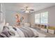 Bright bedroom with a ceiling fan and unique shelving creates a cozy and organized space at 45 Kelsey Way, Palmetto, GA 30268