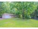 Detached two-car garage in a spacious backyard surrounded by lush greenery providing a private and serene setting at 45 Kelsey Way, Palmetto, GA 30268