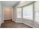 Living room with large windows and wood-look flooring at 45 Kelsey Way, Palmetto, GA 30268