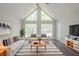 Bright living room features vaulted ceiling, large windows, and stylish black and white accents at 45 Kelsey Way, Palmetto, GA 30268