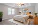 Serene main bedroom boasts a tray ceiling, plush carpet, and a calming, neutral color palette at 45 Kelsey Way, Palmetto, GA 30268