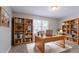 Well-lit home office with a large desk, shelving, and ample storage space for books and decor at 45 Kelsey Way, Palmetto, GA 30268