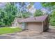 Stunning rear exterior view of home featuring lush backyard, patio, and private driveway at 45 Kelsey Way, Palmetto, GA 30268