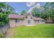 Delightful rear exterior view displaying a verdant backyard, windows, and access to patio at 45 Kelsey Way, Palmetto, GA 30268