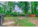 Spacious backyard with mature trees, storage shed and wooden privacy fence at 1024 Regis Rd, Atlanta, GA 30315