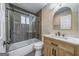 Bathroom features a shower-tub combo and wood vanity with white countertop at 1024 Regis Rd, Atlanta, GA 30315