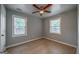 Bedroom features neutral toned floor, ceiling fan, and natural light from the windows at 1024 Regis Rd, Atlanta, GA 30315